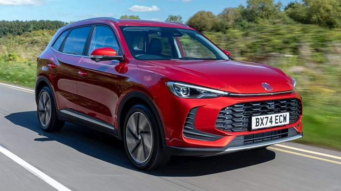 “MG ZS Hybrid+ 2024: Performance and Efficiency Combined in a Compact SUV” “MG ZS Hybrid+ 2024 SUV driving on the road, showcasing its sleek design and hybrid performance.”